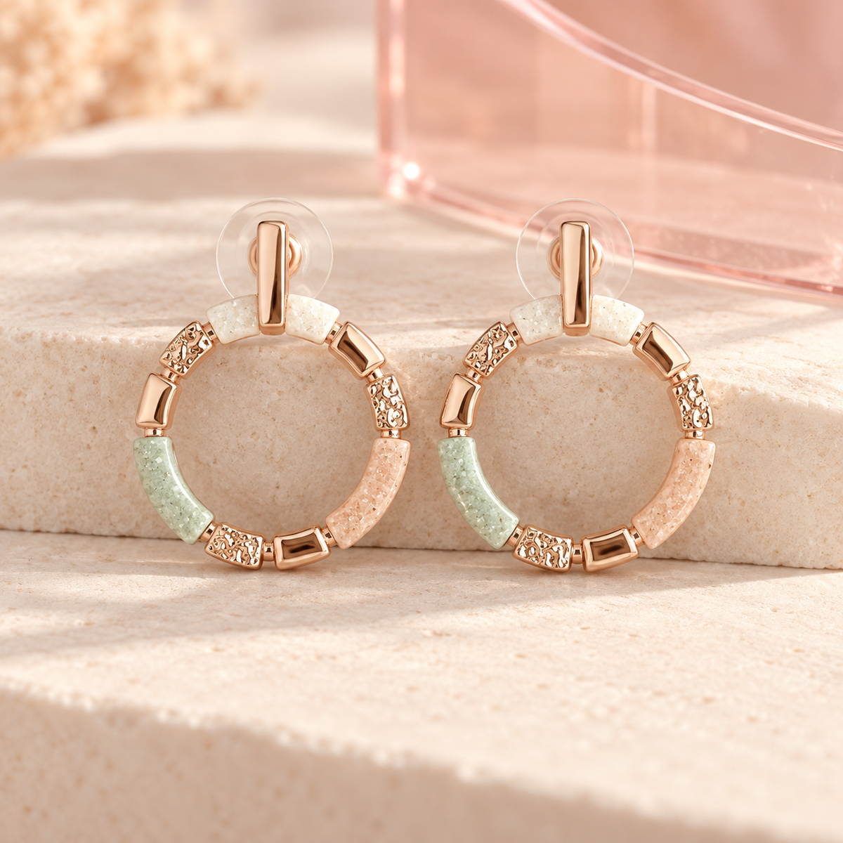 Art Bay Rose Gold Earrings pair on ivory stone with blush acrylic