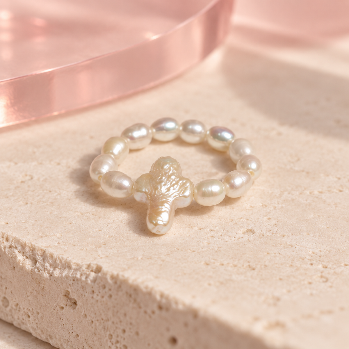 Baroque Pearl Cross Ring on an ivory stone surface