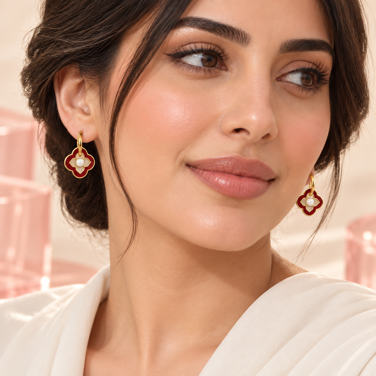 Red and white clover pearl accent hoop earrings worn on model