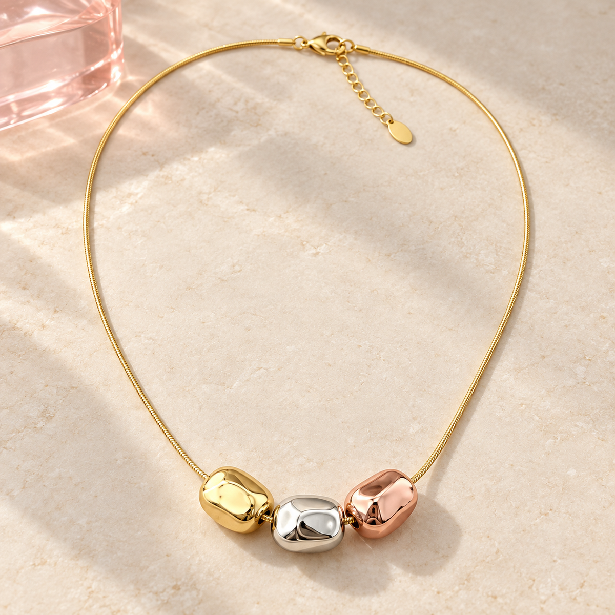 Gili Tri Tone Necklace with three metallic beads on ivory stone and blush acrylic