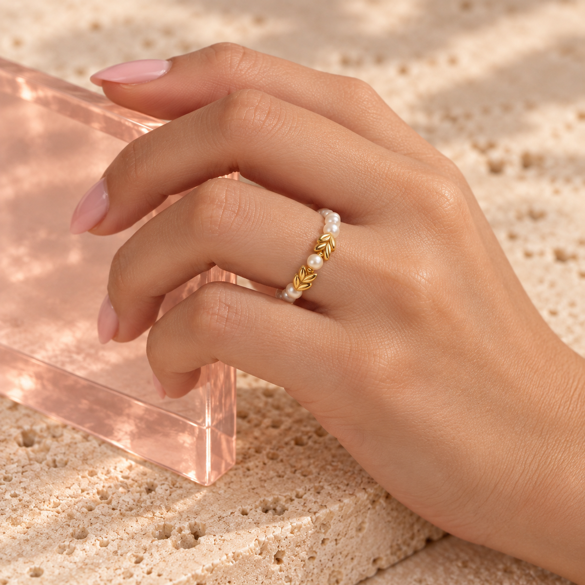 Golden leaves pearl charm ring worn on the ring finger