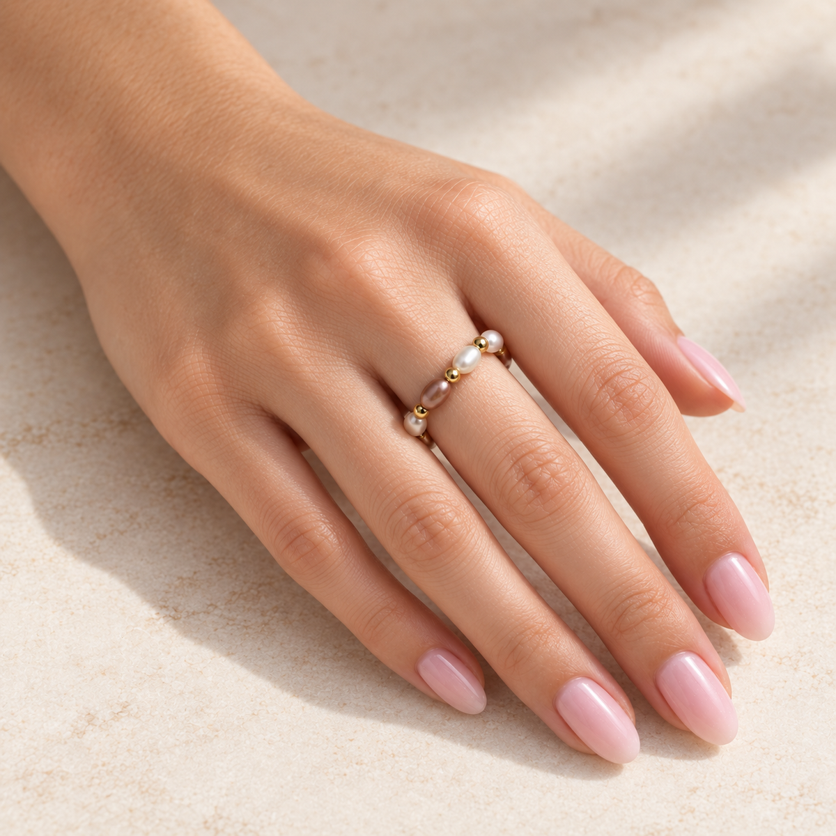 Rosé Pearl Rhythm Ring worn on hand