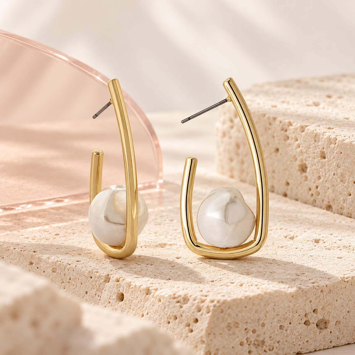 Sculpted Pearl Loop Earrings on cream travertine