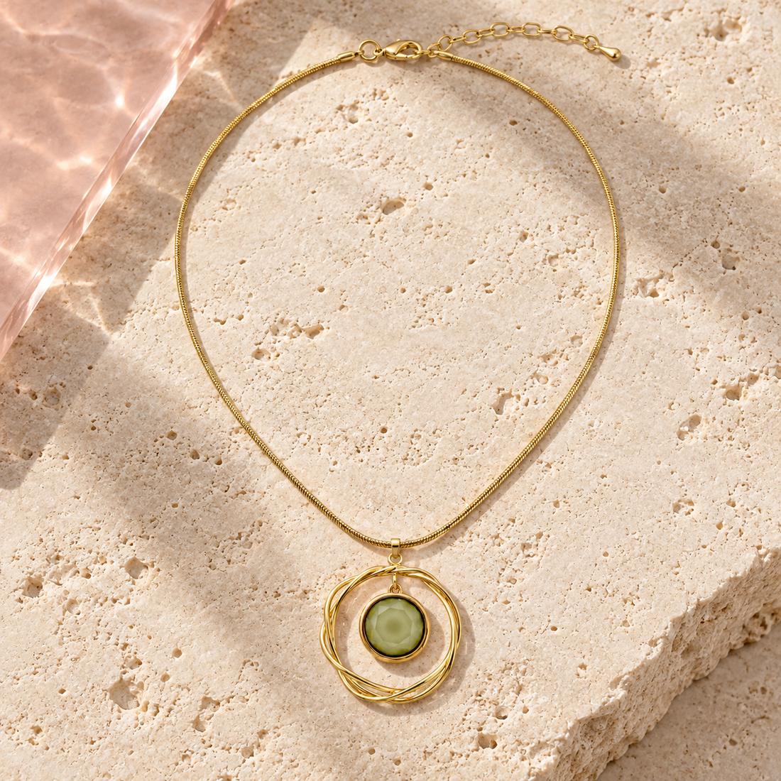 Aurelia Green Orbit Necklace on ivory travertine