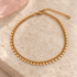 Gold triangle charm anklet on ivory stone