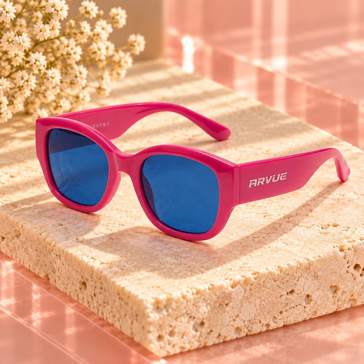Pink ARVUE sunglasses on ivory stone