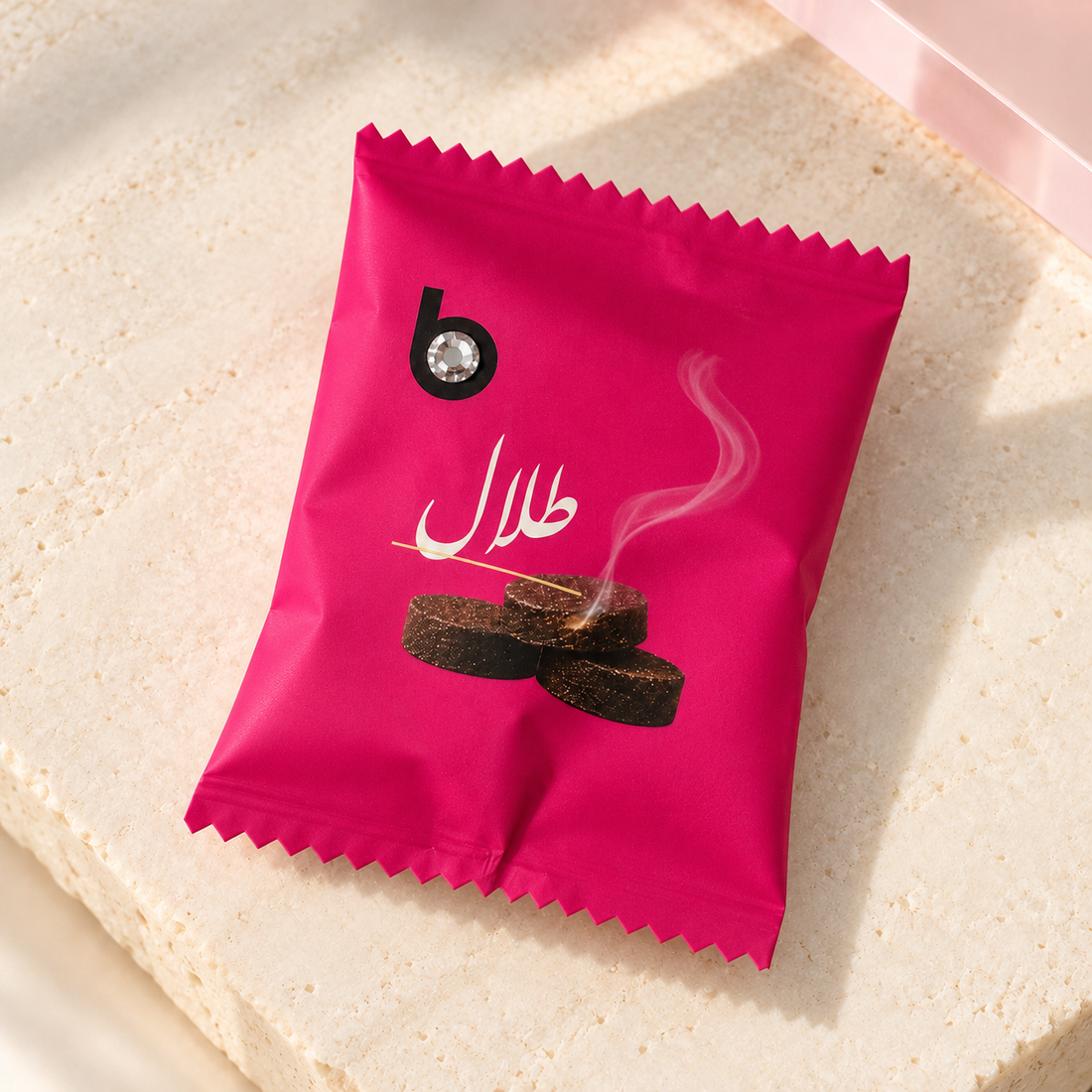 bloomy Bakhour Bonbon Talal individually wrapped sachet on ivory stone