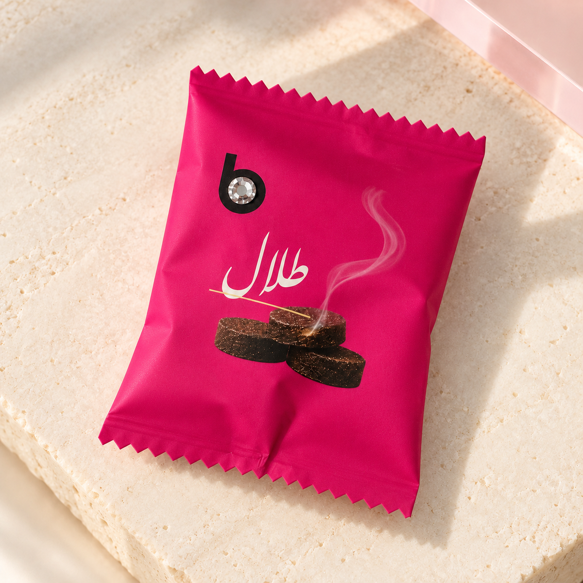 bloomy Bakhour Bonbon Talal individually wrapped sachet on ivory stone