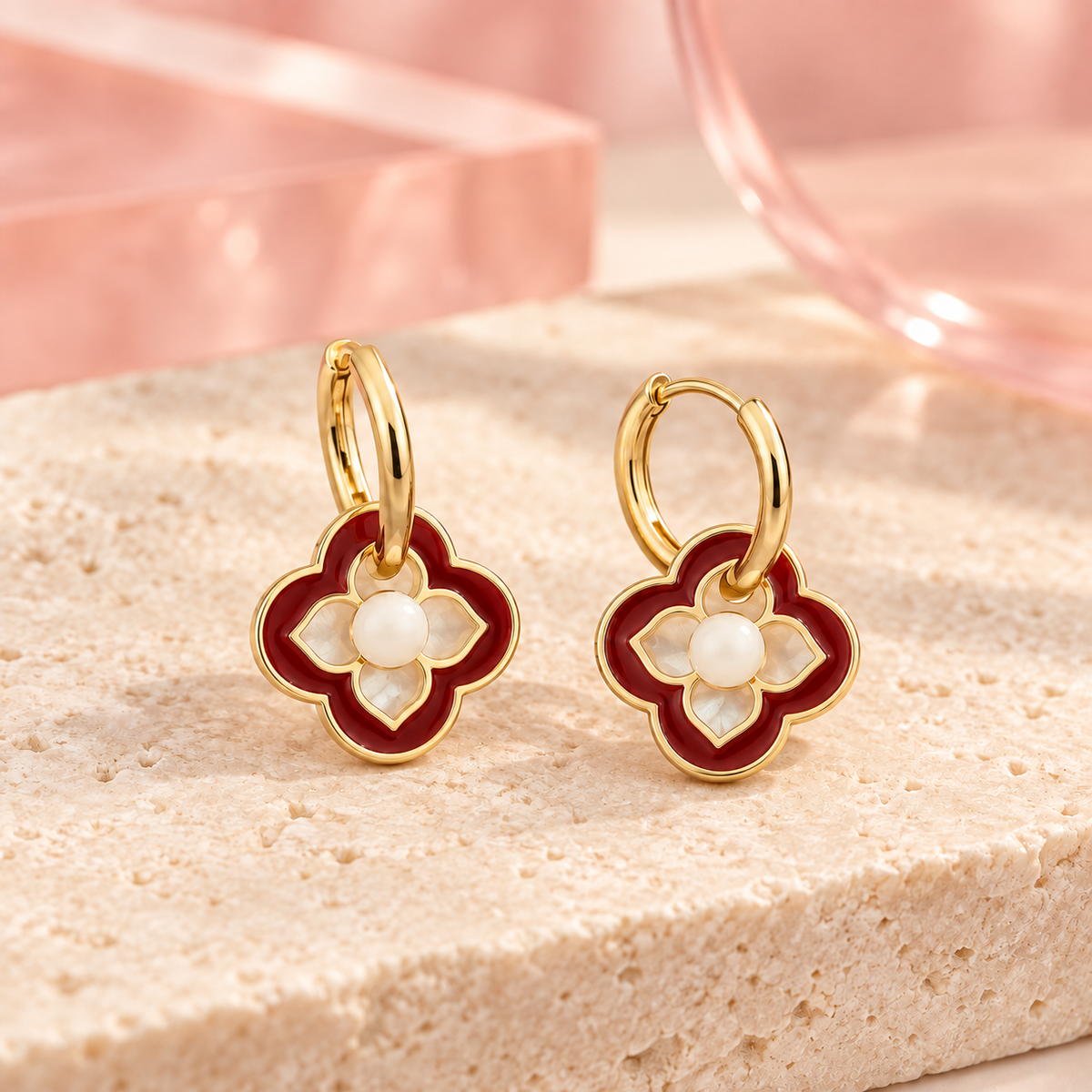 Red and white clover pearl accent hoop earrings on ivory stone