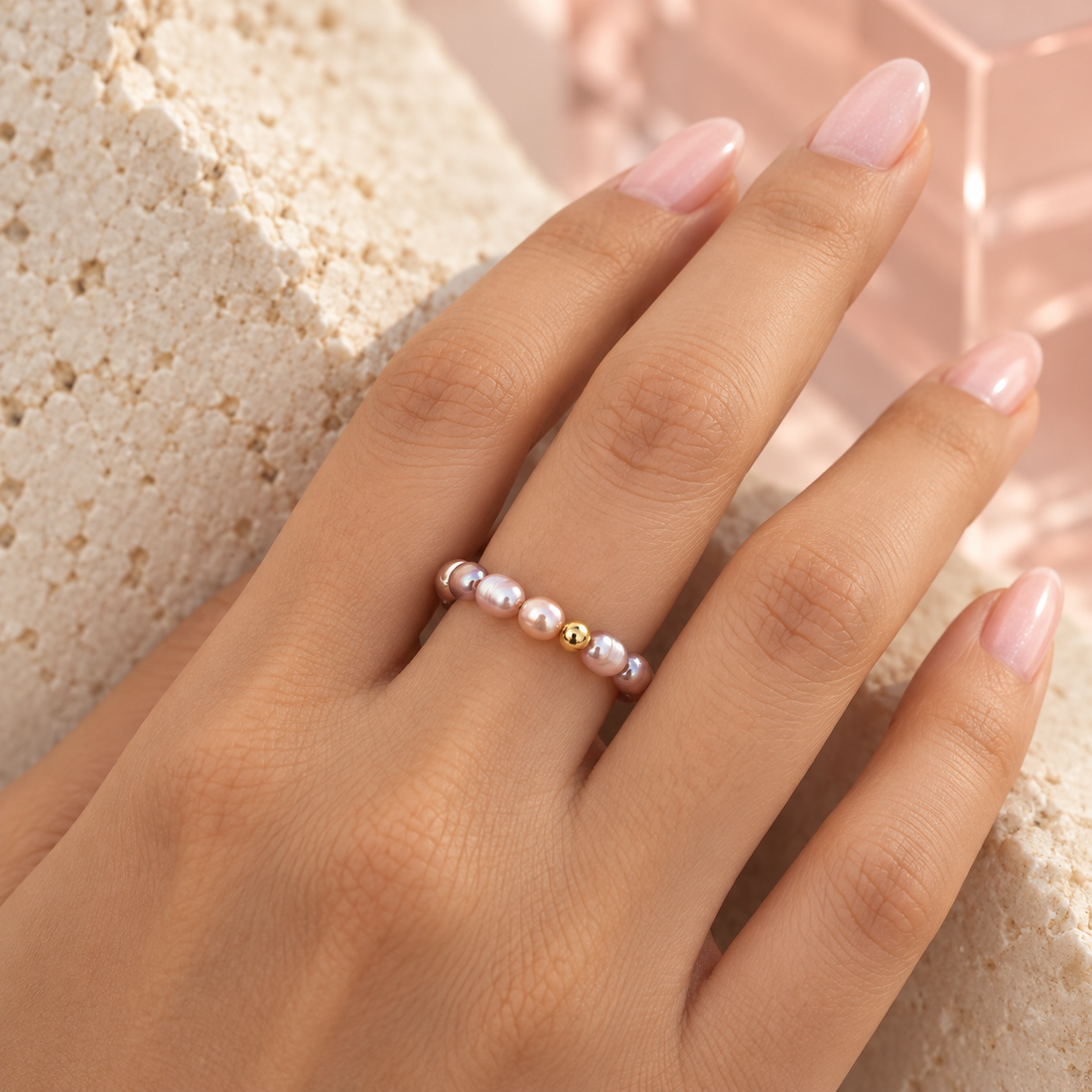 Mixed iridescent pearl ring worn on hand