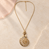 Nerina Spiral Shell Long Gold Necklace on ivory stone