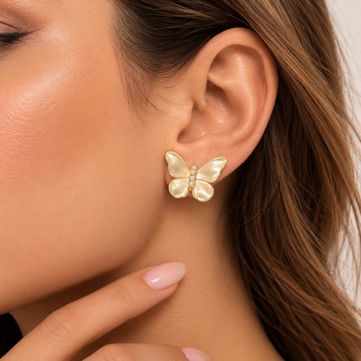 Pearlescent butterfly stud earring worn by Mimi