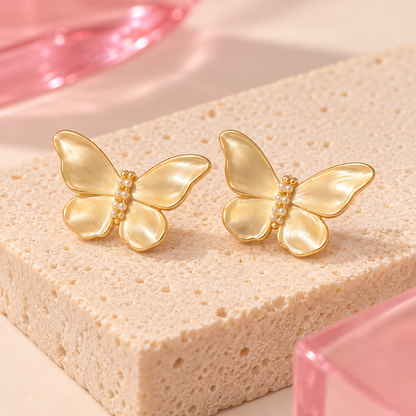 Pearlescent butterfly stud earrings on Bloomy ivory stone