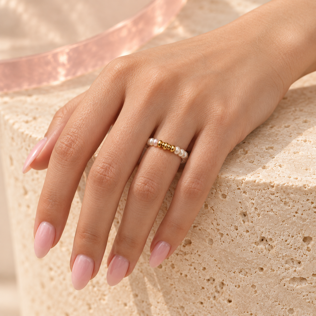 Freshwater pearl ring with gold bead bar worn on the ring finger