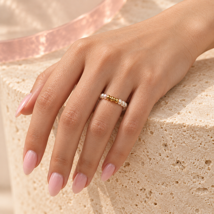 Freshwater pearl ring with gold bead bar worn on the ring finger