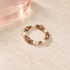 Rosé Pearl Rhythm Ring on an ivory background