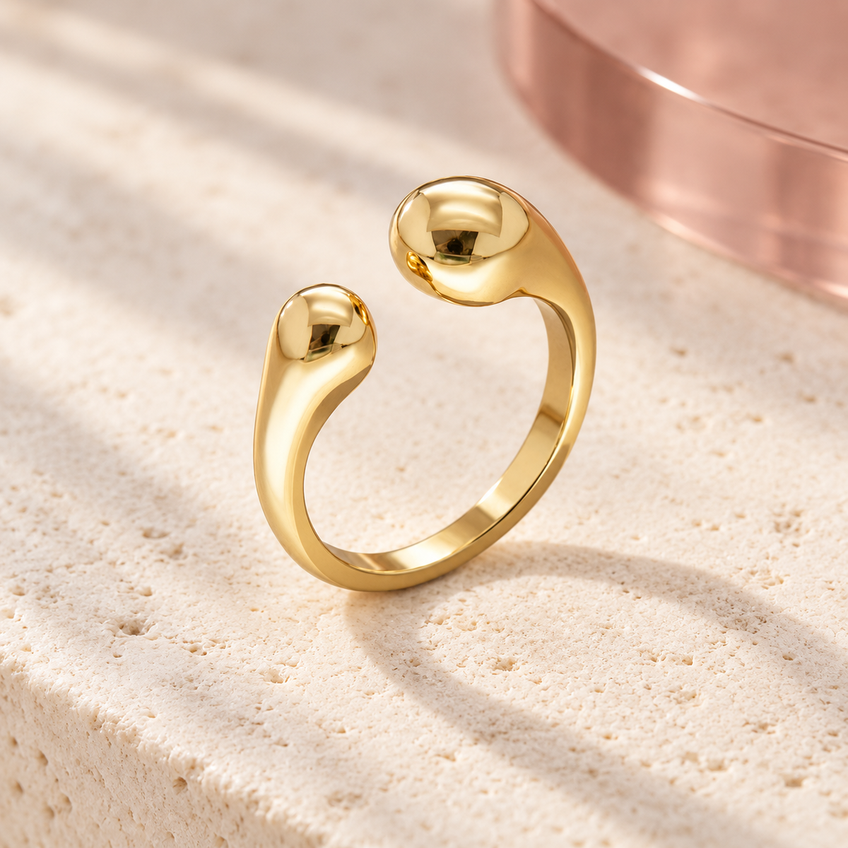 Solea sculpted open gold ring on Bloomy ivory stone and dusty rose backdrop