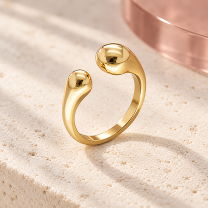 Solea sculpted open gold ring on Bloomy ivory stone and dusty rose backdrop
