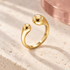 Solea sculpted open gold ring on Bloomy ivory stone and dusty rose backdrop