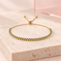 Turquoise Allure adjustable gold bracelet on Bloomy travertine display