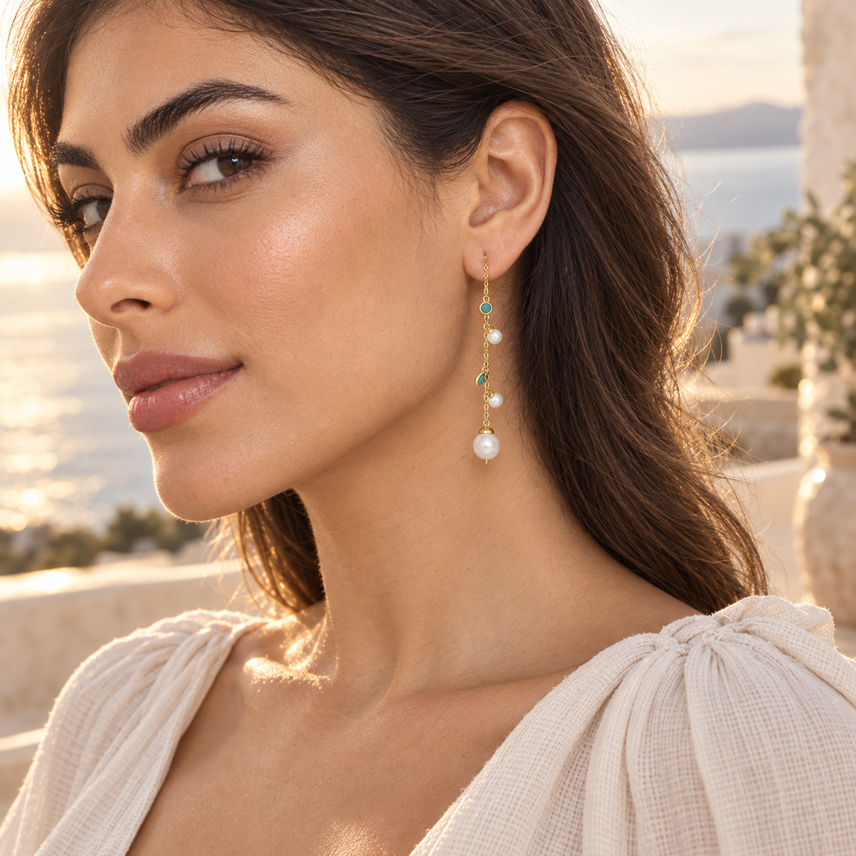 Turquoise Pearl Cascade Earrings worn on a coastal terrace