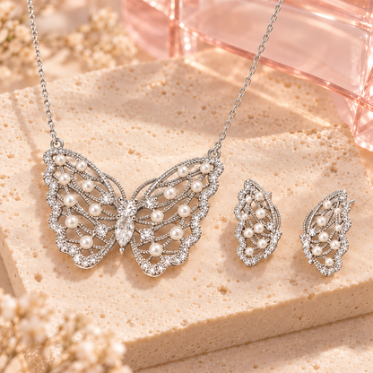 Silver-tone butterfly necklace and matching earrings on ivory stone