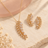 Gold-tone crystal leaf branch necklace and matching earrings