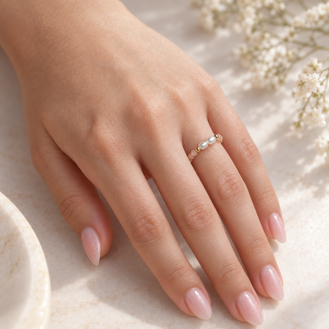 Blush Pearl Whisper Ring by Bloomy styled on a relaxed hand