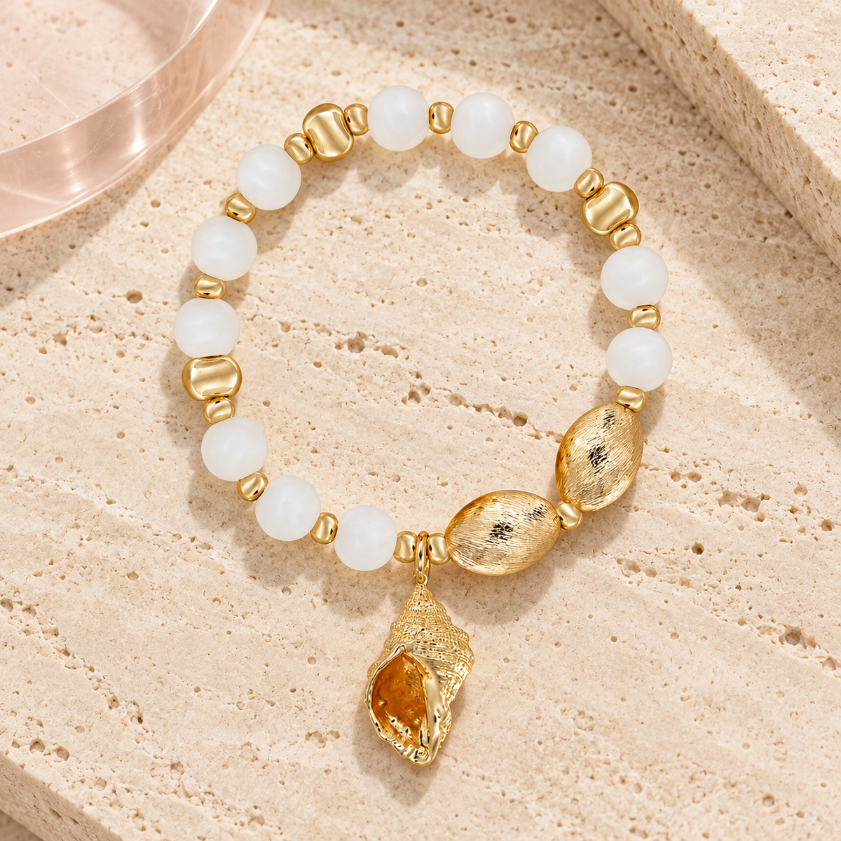 Cita Gold Bracelet with white beads and gold seashell charm