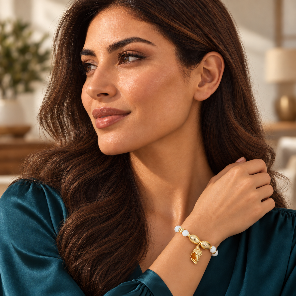 Model wearing Cita Gold Bracelet with teal dress