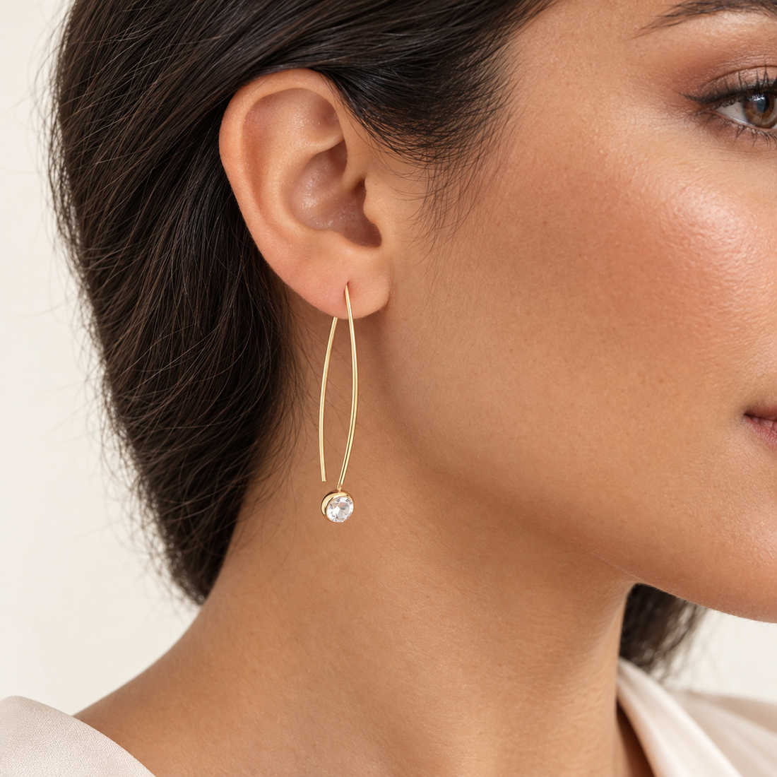 Close-up of Crystal Whisper Threader Earrings worn through the earlobe