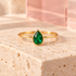 Emerald-green pear-cut crystal ring on ivory stone and translucent blush acrylic