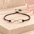 Eterna Rose infinity bracelet with brown braided cord and clear zircon
