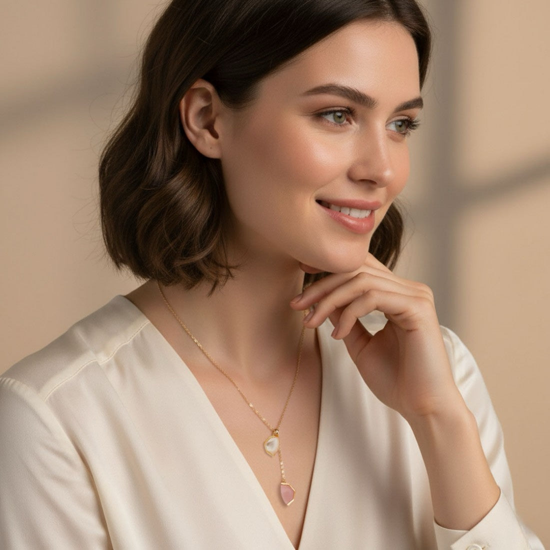 Woman wearing Bloomy Serena Mother-of-Pearl Drop Necklace with ivory blouse