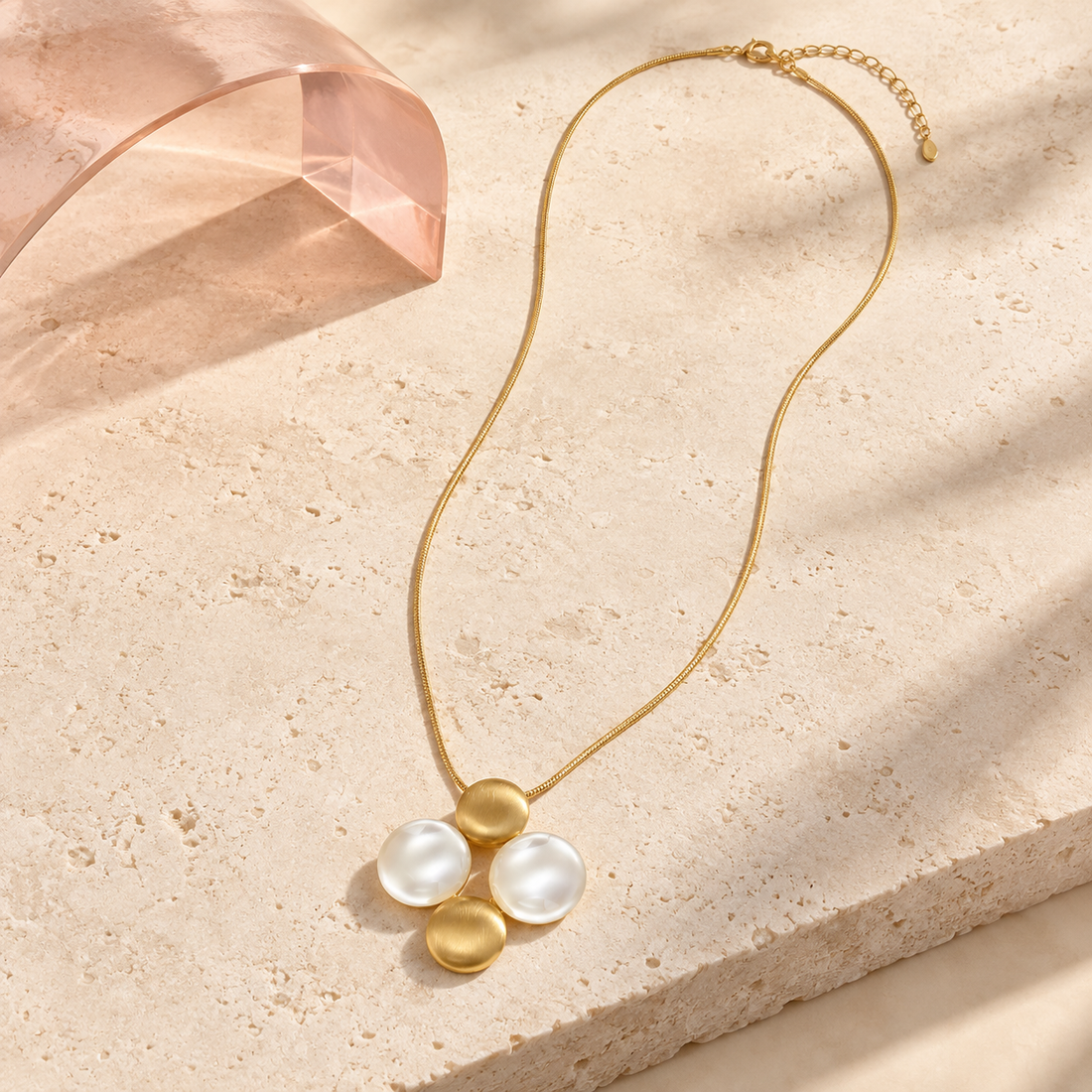 Bloomy Liora Pearl Orbit long gold necklace on ivory stone and blush acrylic