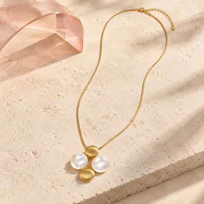 Bloomy Liora Pearl Orbit long gold necklace on ivory stone and blush acrylic