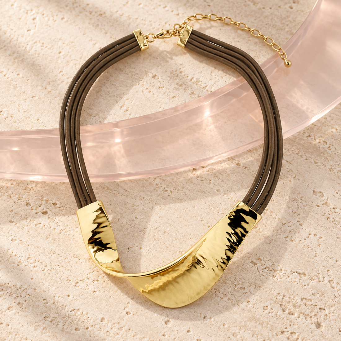 Luna Arc Leather Necklace on Bloomy ivory stone and blush acrylic background