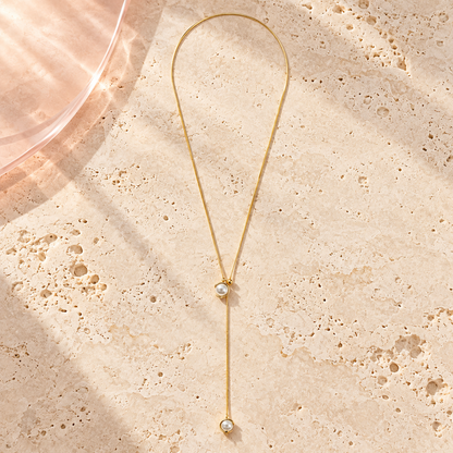 Luna Pearl Lariat Necklace by Bloomy on ivory stone