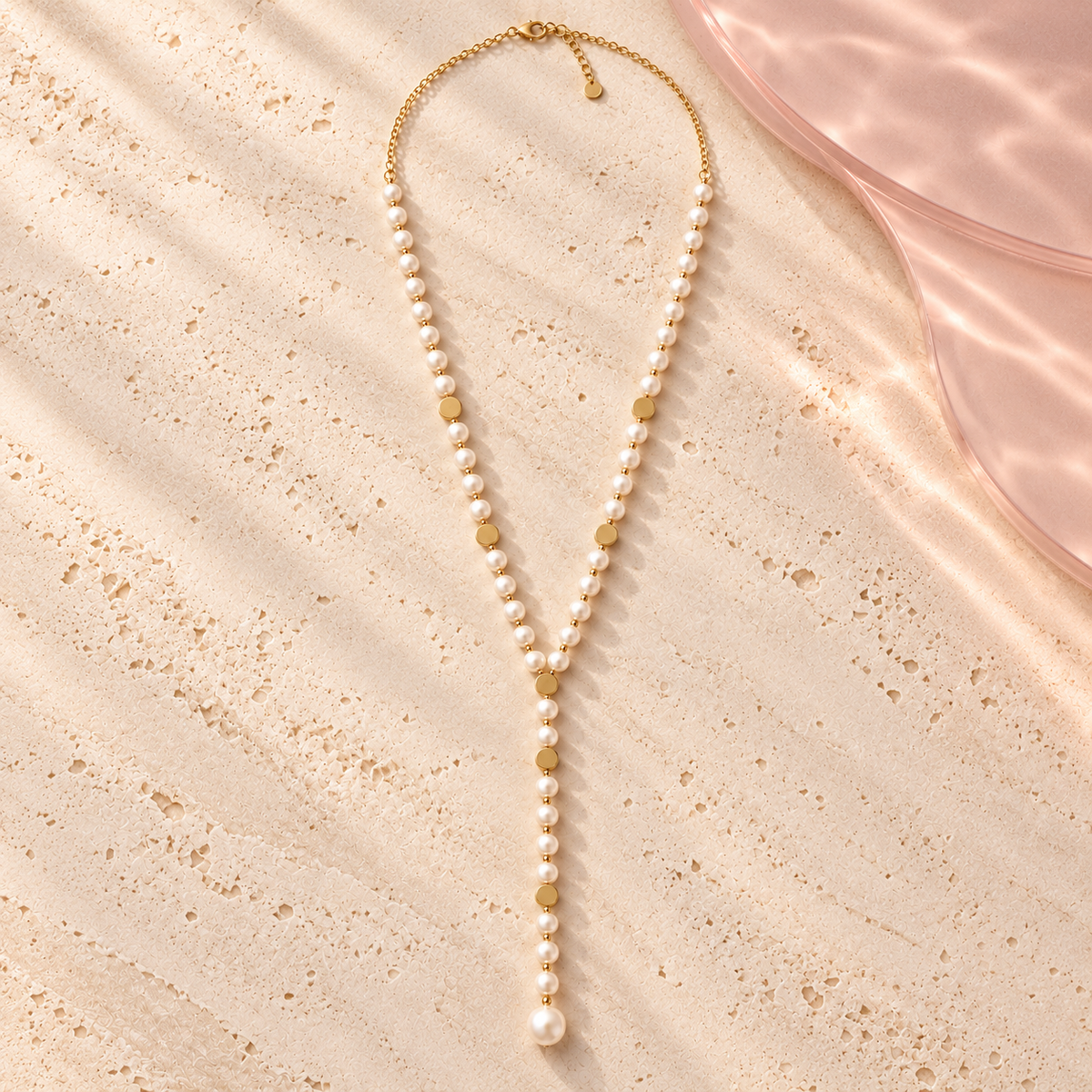 Monalisa Pearl Lariat Necklace laid flat on ivory stone
