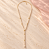 Monalisa Pearl Lariat Necklace laid flat on ivory stone
