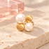 Play Pearl Gold Ring with two pearls and two brushed gold discs on ivory stone with blush acrylic