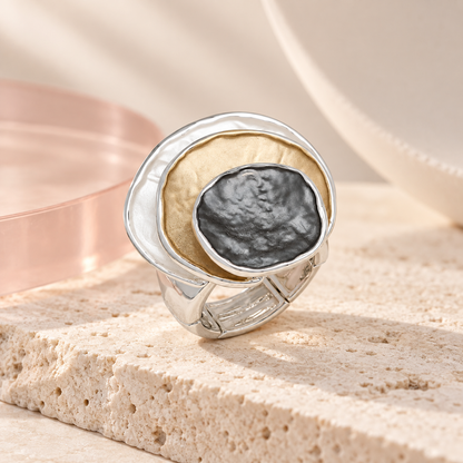 Bloomy Trinity Eclipse Statement Ring on cream travertine